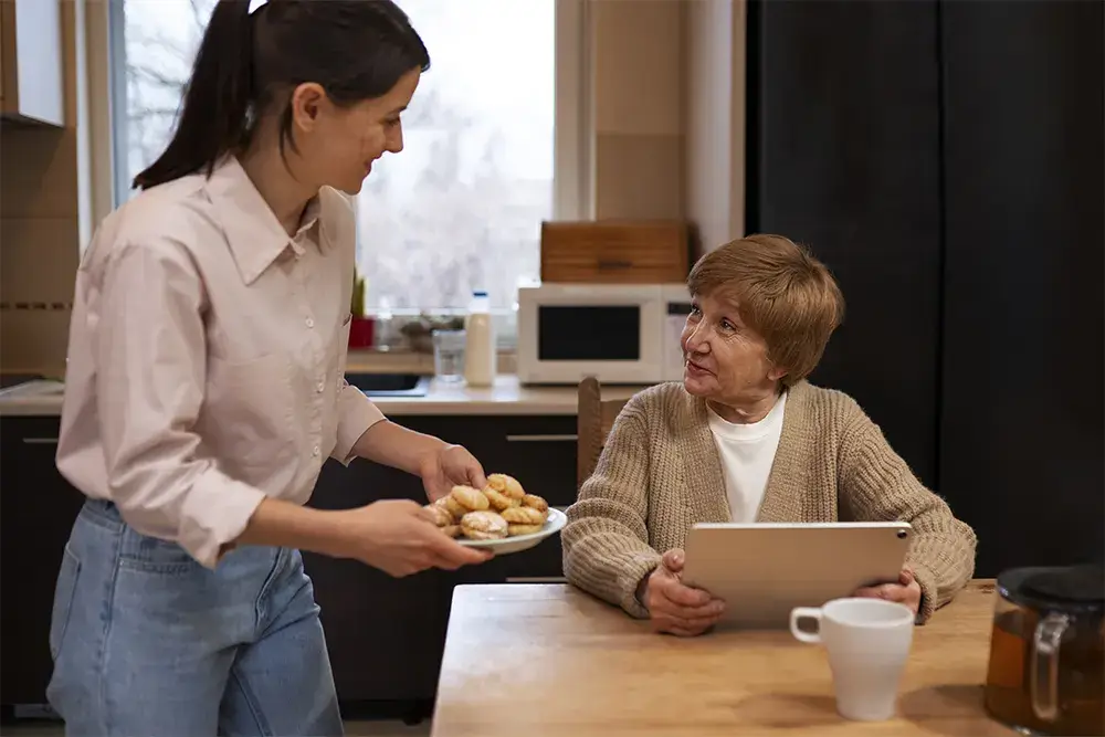 Elderly woman receiving personal care support at home, helping her maintain independence and comfort in daily living.
